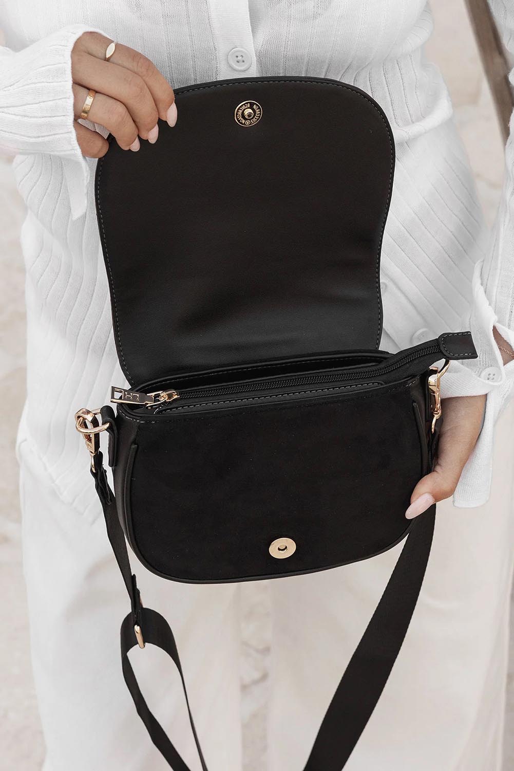 A model wearing the Jade Crossbody Bag in colour Black (Black), from the front, showing the whole outfit