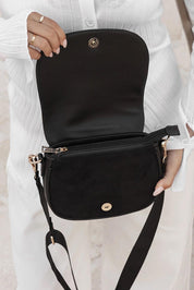 A model wearing the Jade Crossbody Bag in colour Black (Black), from the front, showing the whole outfit