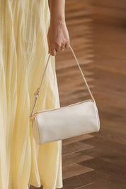 A model wearing the Serena Handbag in colour Vanilla (White), from the front, showing the whole outfit