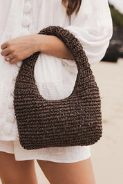 A model wearing the Nellie Woven Handbag in colour Chocolate, from the front, showing the whole outfit