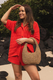 A model wearing the Nellie Woven Handbag in colour Natural, from the front, showing the whole outfit