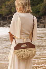 A model wearing the Carmella Bucket Bag in colour Naturtan, from the front, showing the whole outfit