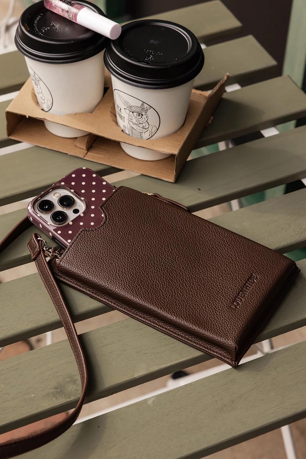A model wearing the Suki Phone Bag in colour Chocolate, from the front, showing the whole outfit