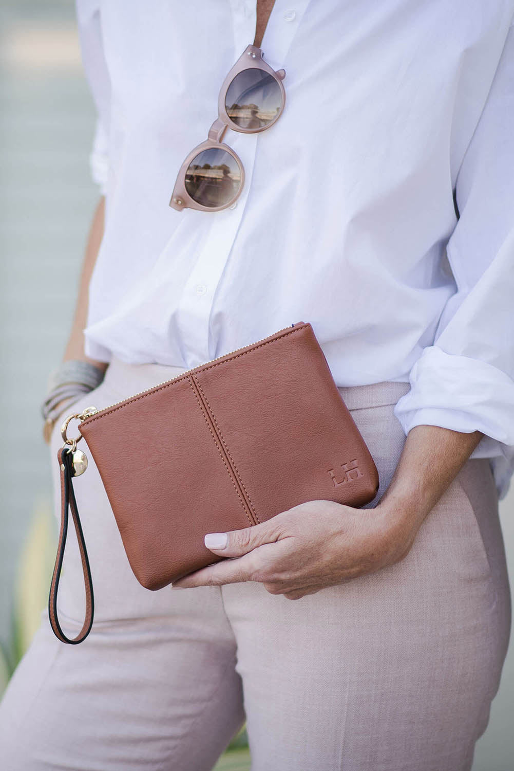 A model wearing the Baby Gracie Clutch in colour Tan, from the front, showing the whole outfit