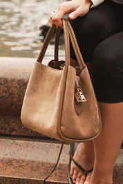 A model wearing the Steffie Suedette Mini Tote Bag in colour Honey, from the front, showing the whole outfit