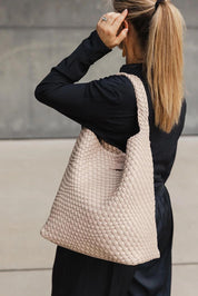 A model wearing the Gabby Woven Shoulder Bag in colour Malt, from the front, showing the whole outfit