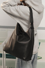 Model Genericm wearing size sample of the Miley Convertible Backpack - Black in colour Black, from an angle