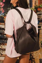 Model Genericm wearing size sample of the Miley Convertible Backpack - Chocolate in colour Chocolate, from an angle