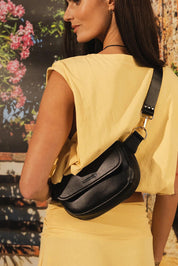 Model Genericm wearing size sample of the Lola Belt Bag - Black in colour Black, from an angle