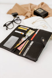A model wearing the Stella Fold Over Wallet in colour Black (Black), from the front, showing the whole outfit