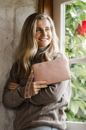 A model wearing the Mandy Clutch in colour Blush (Pink), from the front, showing the whole outfit