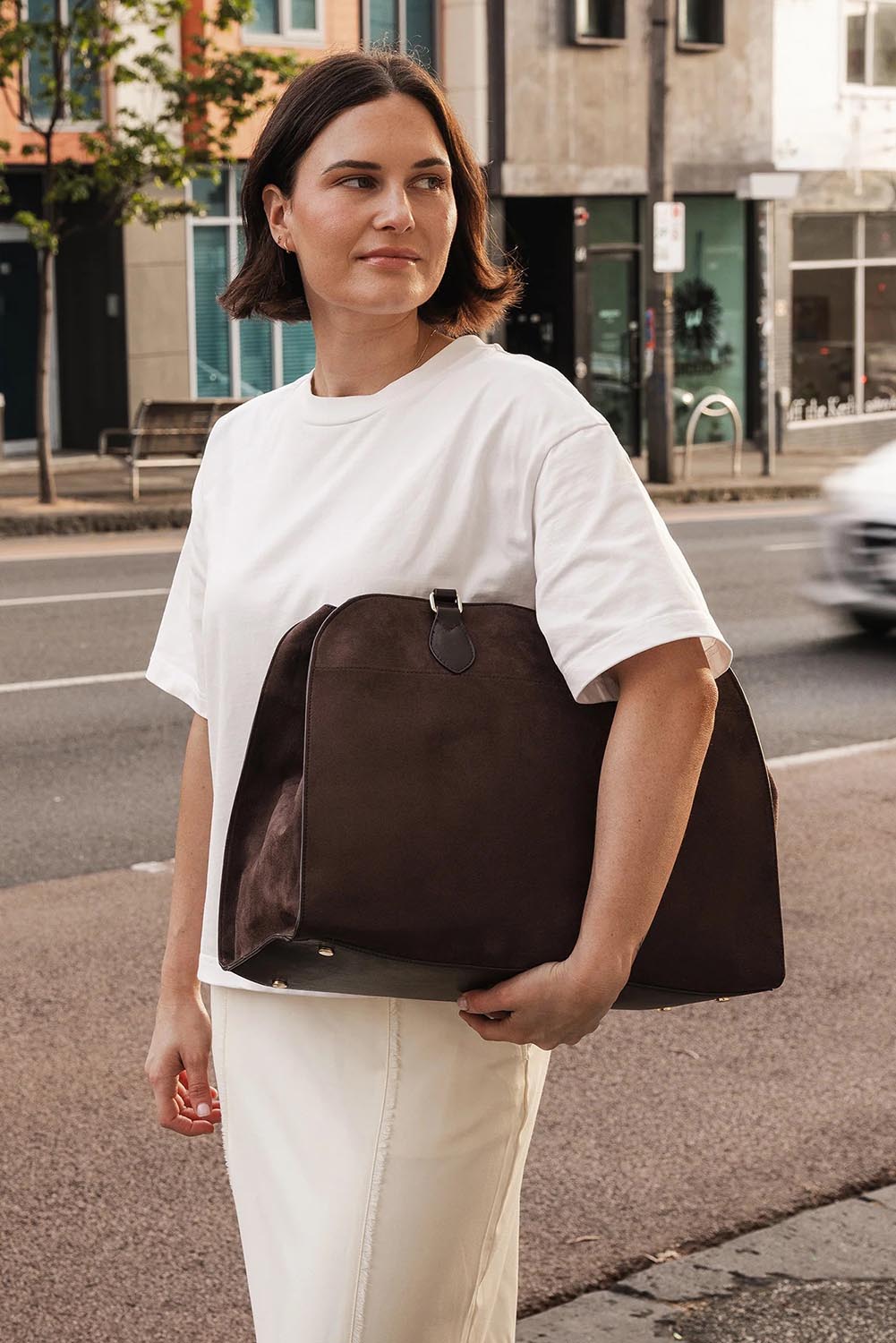 A model wearing the Blaire Tote Bag in colour ChocSuede, from the front, showing the whole outfit
