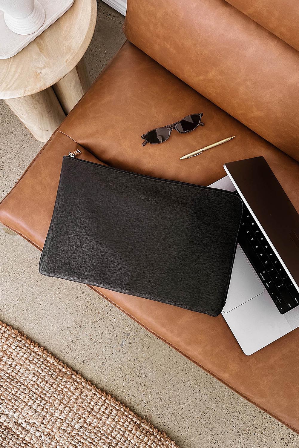 A model wearing the Liv Laptop Sleeve in colour Black (Black), from the front, showing the whole outfit