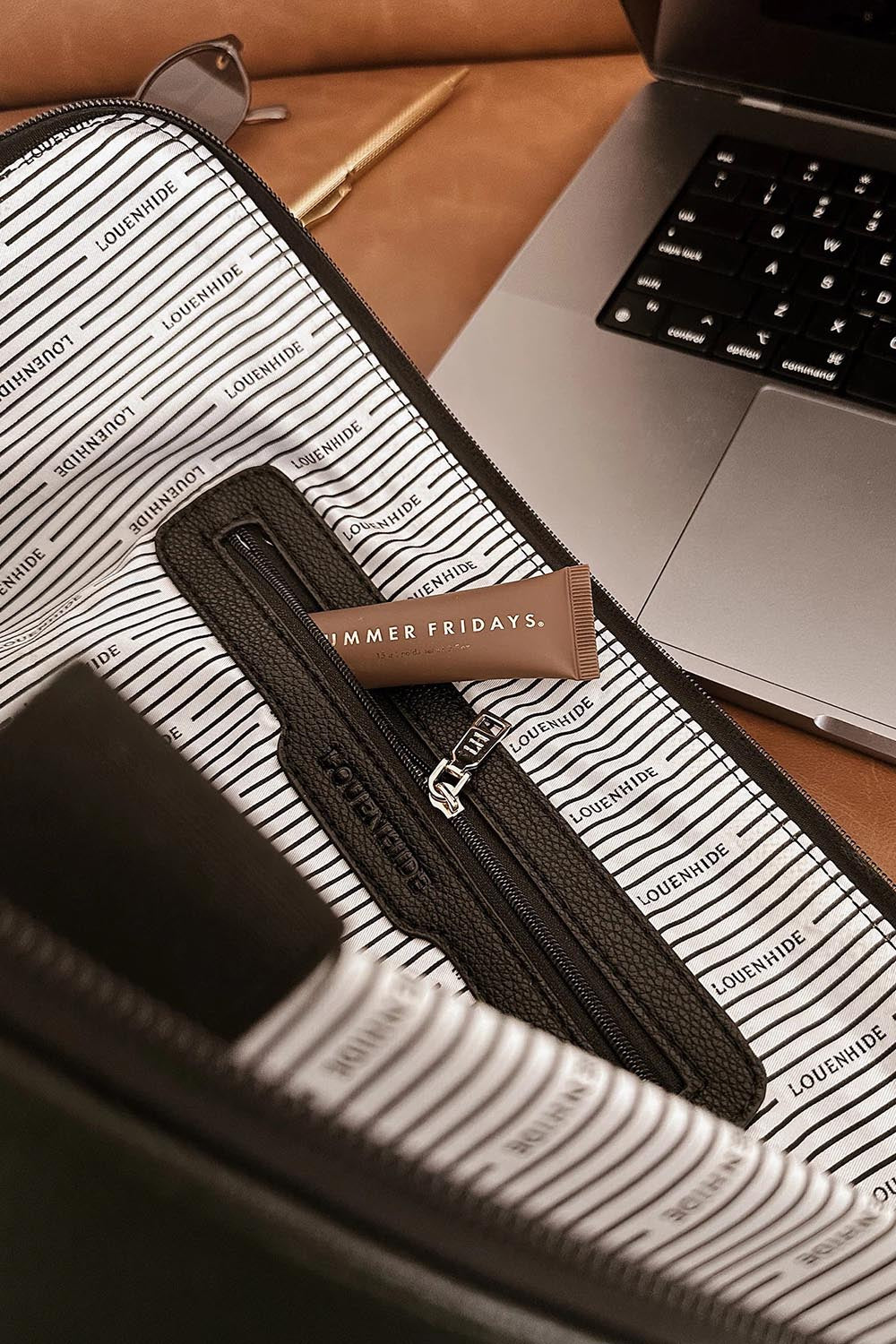 A model wearing the Liv Laptop Sleeve in colour Chocolate, from the front, showing the whole outfit