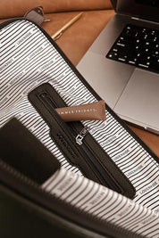 A model wearing the Liv Laptop Sleeve in colour Chocolate, from the front, showing the whole outfit