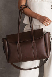 A model wearing the Leighton Tote Bag in colour Chocolate, from the front, showing the whole outfit