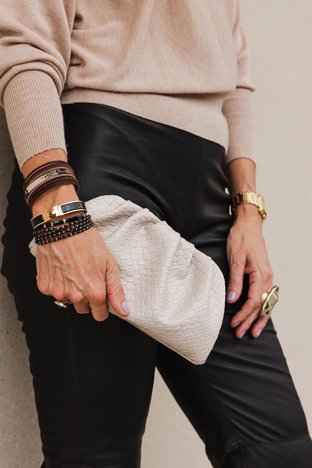 A model wearing the Macy Woven Clutch in colour Malt, from the front, showing the whole outfit