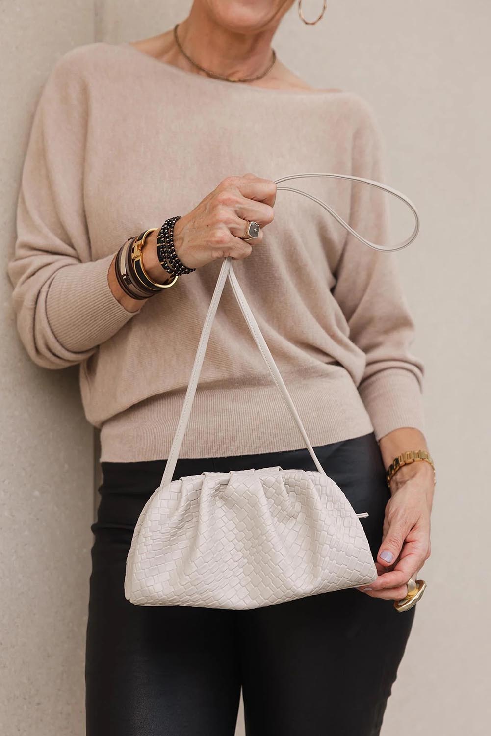 A model wearing the Macy Woven Clutch in colour Malt, from the front, showing the whole outfit