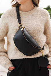 A model wearing the Joey Sling Bag in colour Black (Black), from the front, showing the whole outfit
