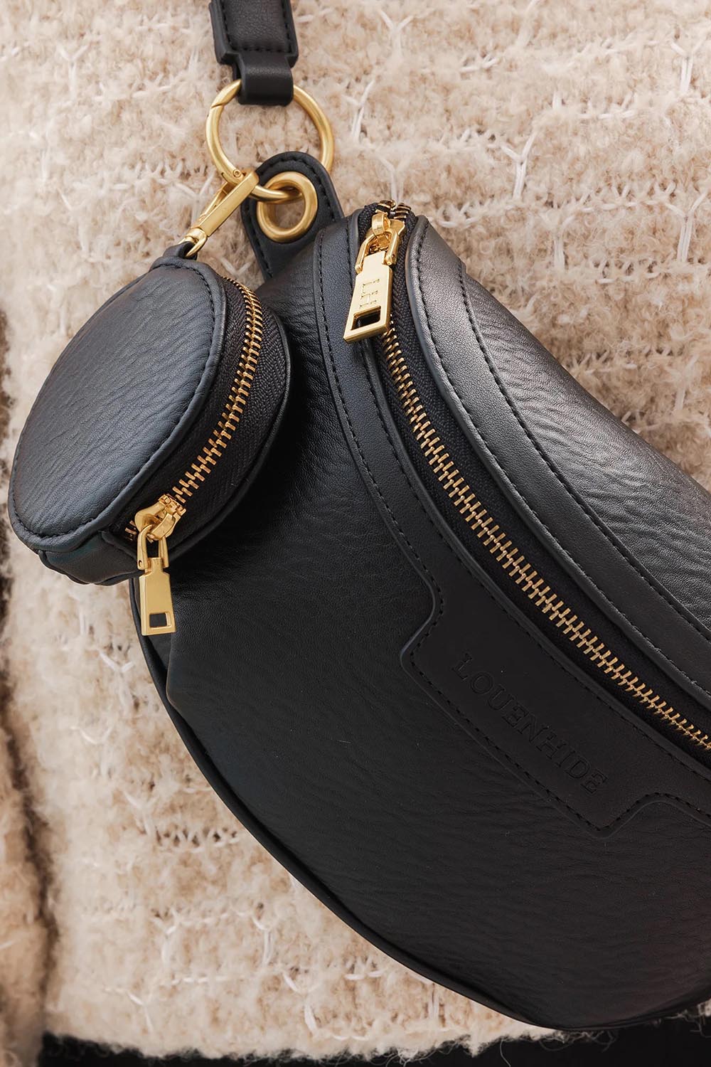 A model wearing the Joey Sling Bag in colour Black (Black), from the front, showing the whole outfit