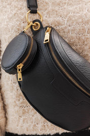A model wearing the Joey Sling Bag in colour Black (Black), from the front, showing the whole outfit