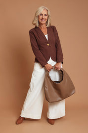 Model Sandy wearing size OneSize of the Monaco Shoulder Bag in colour Tan, from the front, showing the whole outfit