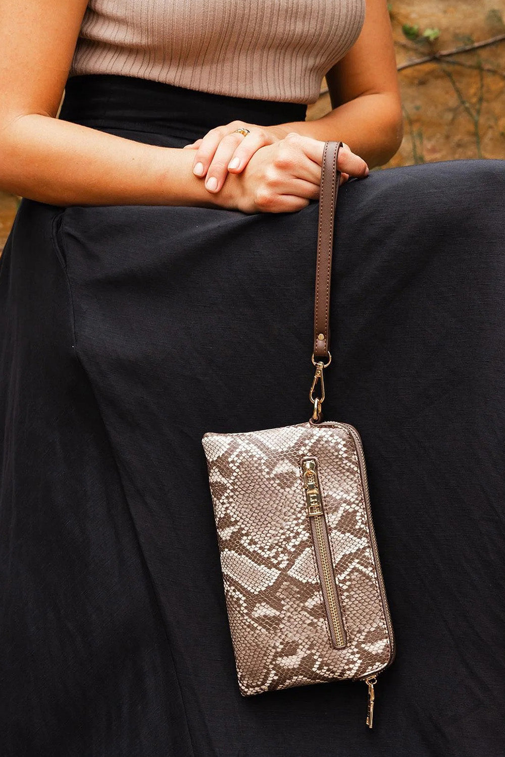 A model wearing the Poppy Clutch in colour Pythoncoff, from the front, showing the whole outfit