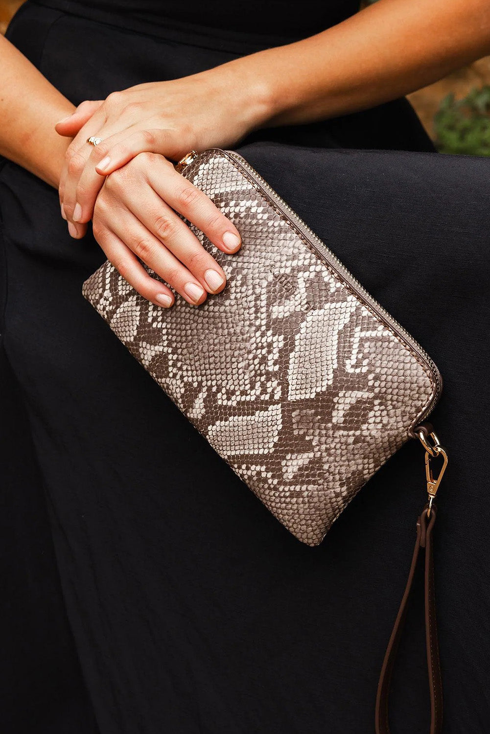 A model wearing the Poppy Clutch in colour Pythoncoff, from the front, showing the whole outfit