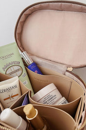 A model wearing the Juliette Toiletries Bag in colour Tan, from the front, showing the whole outfit