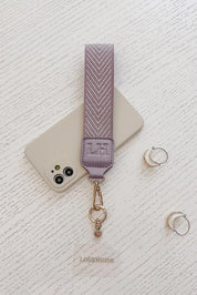 A model wearing the Iris Keyring With Phone Attachment in colour Lilac (Purple), from the front, showing the whole outfit