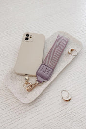 A model wearing the Iris Keyring With Phone Attachment in colour Lilac (Purple), from the front, showing the whole outfit
