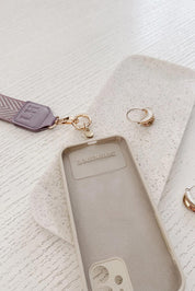 A model wearing the Iris Keyring With Phone Attachment in colour Lilac (Purple), from the front, showing the whole outfit