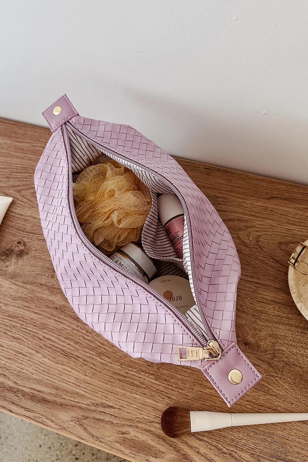 A model wearing the Lucinda Woven Toiletries Bag in colour Lilac (Purple), from the front, showing the whole outfit