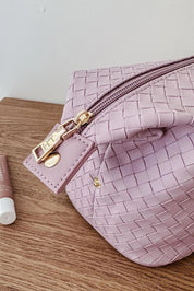 A model wearing the Lucinda Woven Toiletries Bag in colour Lilac (Purple), from the front, showing the whole outfit