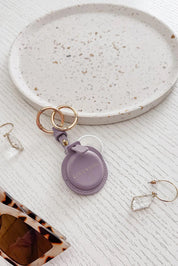 A model wearing the Opal Airtag Holder in colour Lilac (Purple), from the front, showing the whole outfit