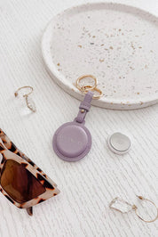 A model wearing the Opal Airtag Holder in colour Lilac (Purple), from the front, showing the whole outfit