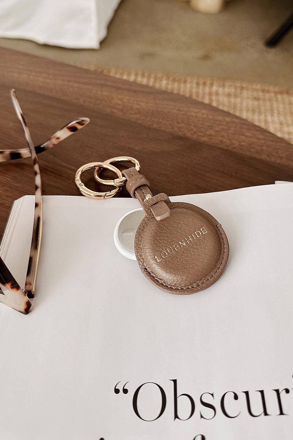 A model wearing the Opal Airtag Holder in colour Mocha, from the front, showing the whole outfit