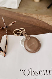 A model wearing the Opal Airtag Holder in colour Mocha, from the front, showing the whole outfit
