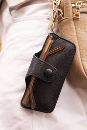A model wearing the Skittles Glasses Case in colour Black (Black), from the front, showing the whole outfit