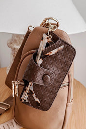 A model wearing the Woven Skittle Glasses Case in colour Chocolate, from the front, showing the whole outfit