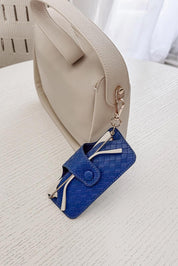 A model wearing the Woven Skittle Glasses Case in colour OceanBlue (Blue), from the front, showing the whole outfit