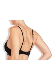 A model wearing the Simply Seamless Wirefree Bra in colour Black (Black), from the back