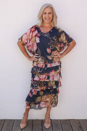 Model Sandy wearing the Silk Blend Multi Layers Dress in colour Navyfloral (Blue), from the front, showing the whole outfit