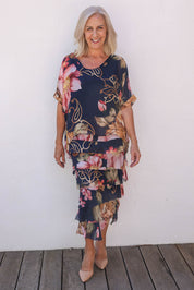 Model Sandy wearing the Silk Blend Multi Layers Dress in colour Navyfloral (Blue), from the front, showing the whole outfit
