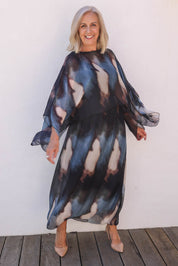 Model Sandy wearing the Silk Blend Cape Dress in colour Nero (Blue), from the front, showing the whole outfit