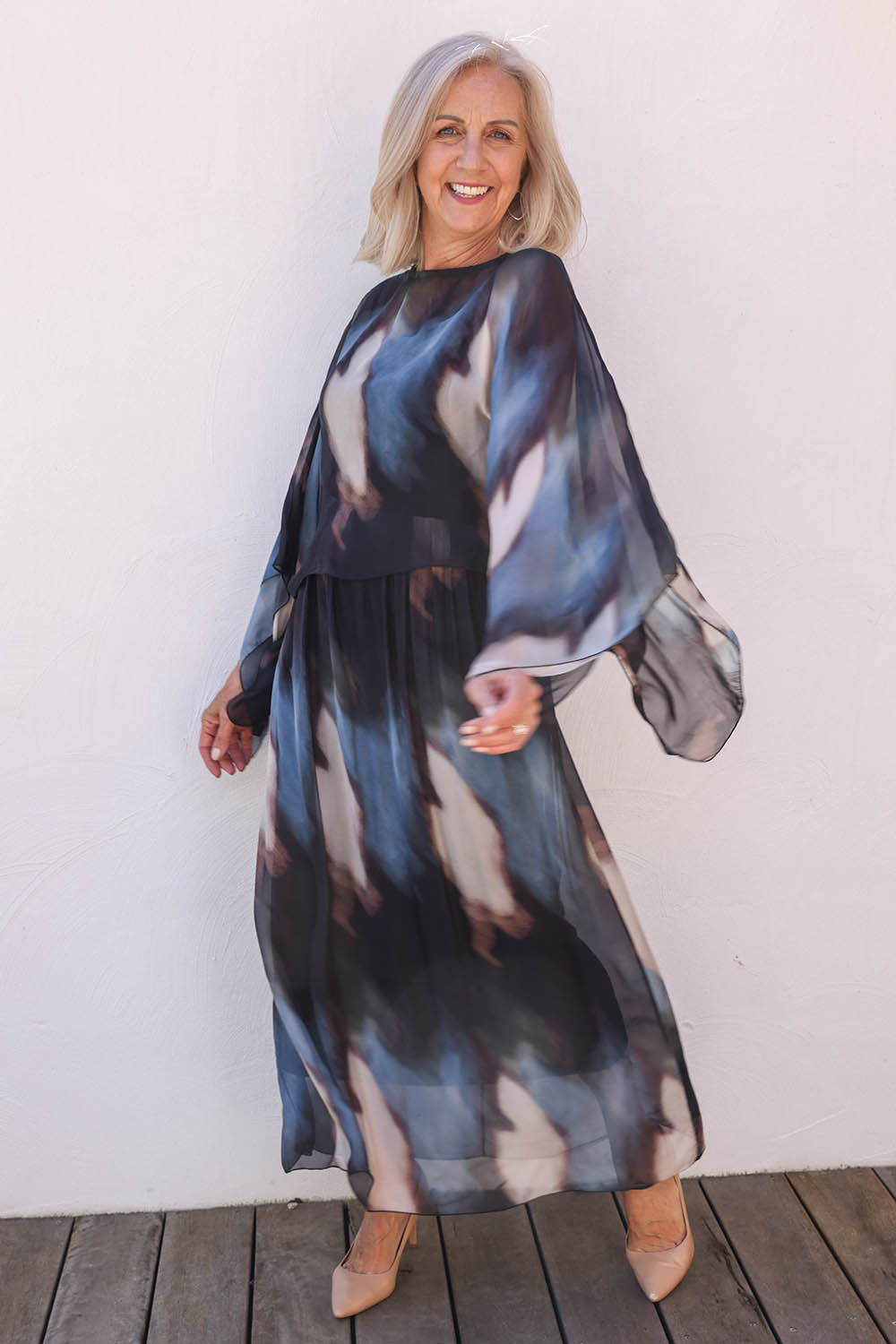Model Sandy wearing the Silk Blend Cape Dress in colour Nero (Blue), from the front, showing the whole outfit
