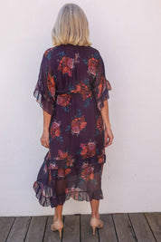Model Sandy wearing the Frill Sleeve Silk Blend Print Dress in colour Orchidea (Purple), from the back