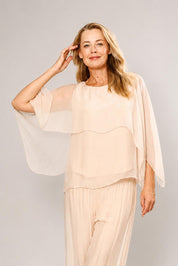 Model Genericm wearing size sample of the Silk Blend Cape Top - Beige in colour Beige, from the front