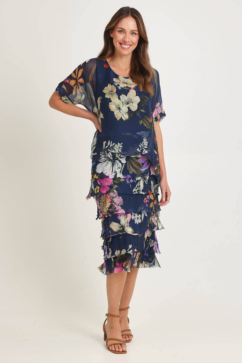 Model Madeline wearing the Silk Blend Multi Layer Print Dress in colour Navyfloral (Blue), from the front, showing the whole outfit
