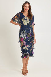Model Madeline wearing the Silk Blend Multi Layer Print Dress in colour Navyfloral (Blue), from the front, showing the whole outfit